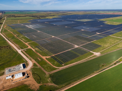 Aerial view of Limondale Solar Farm featuring vast rows of photovoltaic panels set within a rural landscape of green fields and dirt tracks in Balranald New South Wales Australia. Aerial view of Limondale Solar Farm featuring vast rows of photovoltaic panels set within a rural landscape of green fields and dirt tracks in Balranald New South Wales Australia.