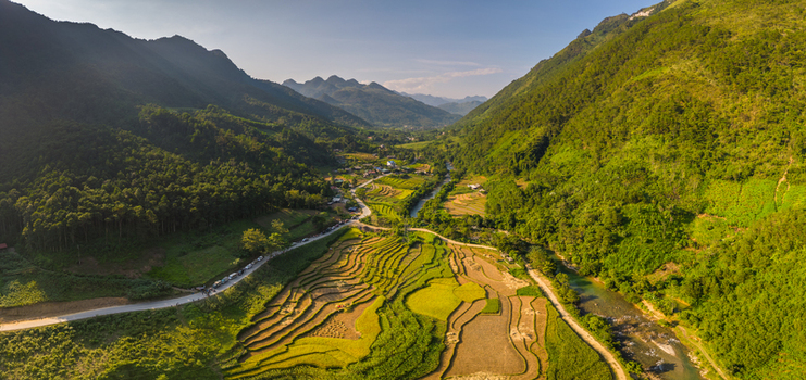 Aerial view of the terraced rice fields and winding river near Nha cua Nuong in the mountainous valley of Quan Ba Tuyen Quang Vietnam.