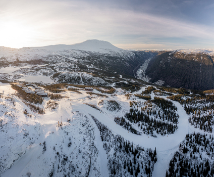 Aerial view of Gaustablikk Fjellresort nestled in the snow covered mountains with ski slopes pine forests and winter landscape in Rjukan Telemark Norway. Aerial view of Gaustablikk Fjellresort nestled in the snow covered mountains with ski slopes pine forests and winter landscape in Rjukan Telemark Norway.