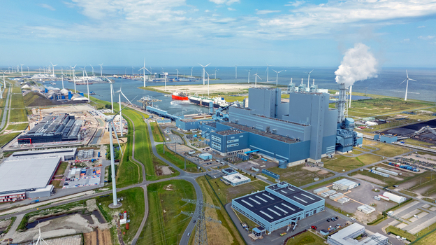 Aerial view of the power plant with surrounding wind turbines industrial facilities and harbor infrastructure in Eemshaven Groningen Netherlands. Aerial view of the power plant with surrounding wind turbines industrial facilities and harbor infrastructure in Eemshaven Groningen Netherlands.