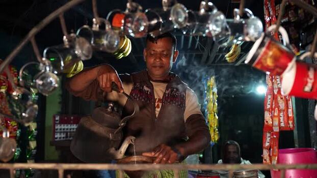 View of a man pouring tea at a street stall in Bogura Bangladesh.