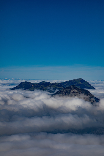 Aerial view of Swiss Alps peaks rising above a sea of clouds in Airolo Ticino Switzerland. Aerial view of Swiss Alps peaks rising above a sea of clouds in Airolo Ticino Switzerland.