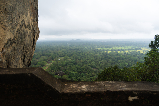 View of the lush jungle canopy and distant misty mountains from the ancient rock fortress Sigiriya Central Province Sri Lanka. View of the lush jungle canopy and distant misty mountains from the ancient rock fortress Sigiriya Central Province Sri Lanka.