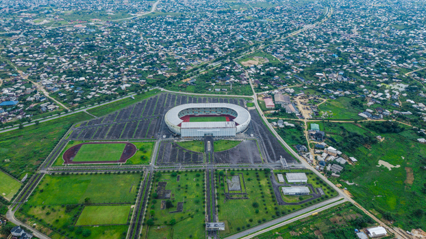 Aerial view of Godswill Akpabio Stadium surrounded by lush green fields parking lots and the urban landscape of Uyo Akwa Ibom Nigeria. Aerial view of Godswill Akpabio Stadium surrounded by lush green fields parking lots and the urban landscape of Uyo Akwa Ibom Nigeria.