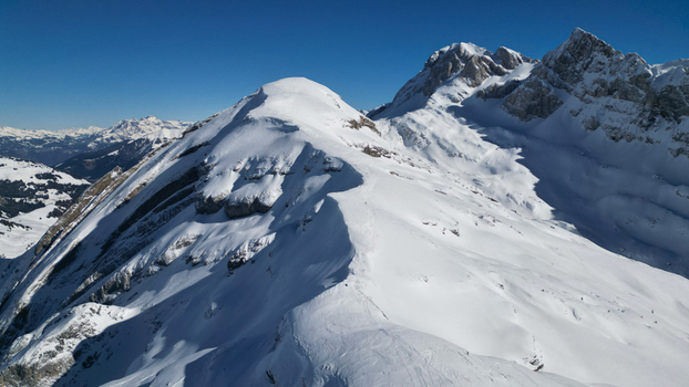 Aerial view of snow dusted peaks under a crisp blue sky revealing the rugged beauty of the French Alps Samoëns Auvergne Rhône Alpes France. Aerial view of snow dusted peaks under a crisp blue sky revealing the rugged beauty of the French Alps Samoëns Auvergne Rhône Alpes France.