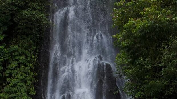 Aerial view of waterfall in tropical forest Indonesia.