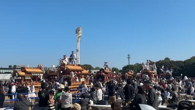 View of ornate festival floats and stadium lights Japan.