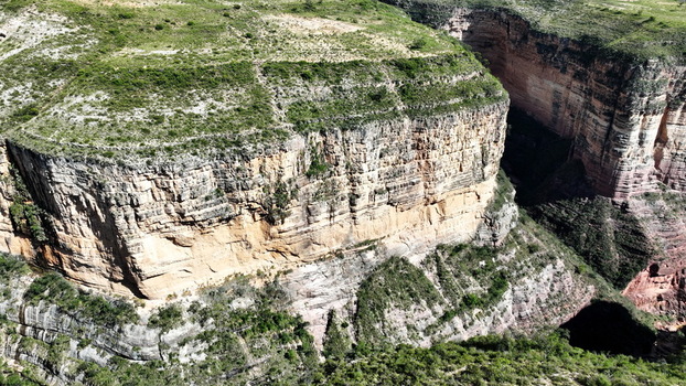 Aerial view of El Vergel canyon featuring steep rock walls lush green vegetation on the plateau and deep geological formations in Torotoro Potosi Department Bolivia. Aerial view of El Vergel canyon featuring steep rock walls lush green vegetation on the plateau and deep geological formations in Torotoro Potosi Department Bolivia.