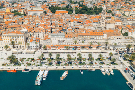 Aerial view of the Riva promenade and historic old town with red tiled roofs and boats moored in the harbor in Split Split Dalmatia County Croatia. Aerial view of the Riva promenade and historic old town with red tiled roofs and boats moored in the harbor in Split Split Dalmatia County Croatia.