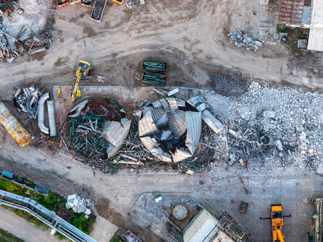 Aerial view of the demolition site at the Heizkraftwerk Klingenberg combined heat and power plant with collapsed metal structures debris and excavators in Berlin Berlin Germany. Aerial view of the demolition site at the Heizkraftwerk Klingenberg combined heat and power plant with collapsed metal structures debris and excavators in Berlin Berlin Germany.