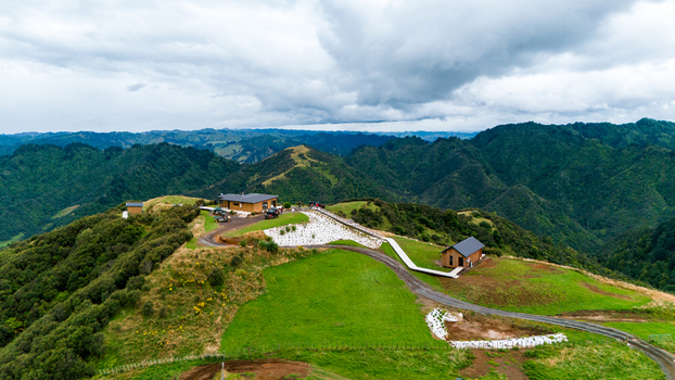 Aerial view of The Chef s Table at Blue Duck Station amidst rolling hills a vivid tapestry of green and brown under a dramatic sky Retaruke Manawatu Whanganui Region New Zealand. Aerial view of The Chef s Table at Blue Duck Station amidst rolling hills a vivid tapestry of green and brown under a dramatic sky Retaruke Manawatu Whanganui Region New Zealand.