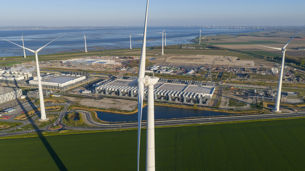 Aerial view of the Google Data Center surrounded by wind turbines and green fields near the coast in Eemshaven Groningen Netherlands. Aerial view of the Google Data Center surrounded by wind turbines and green fields near the coast in Eemshaven Groningen Netherlands.