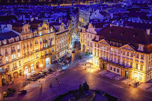 Aerial view of the historic Old Town Square in Prague at night featuring illuminated baroque architecture cobblestone streets and parked cars in Prague Prague Czechia. Aerial view of the historic Old Town Square in Prague at night featuring illuminated baroque architecture cobblestone streets and parked cars in Prague Prague Czechia.