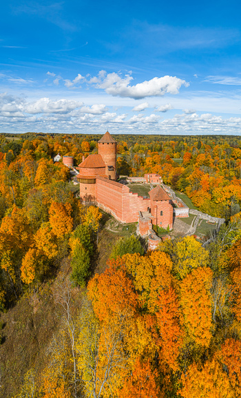 Aerial view of Turaida Castle surrounded by vibrant autumn foliage and dense forest in Sigulda Sigulda Municipality Latvia. Aerial view of Turaida Castle surrounded by vibrant autumn foliage and dense forest in Sigulda Sigulda Municipality Latvia.