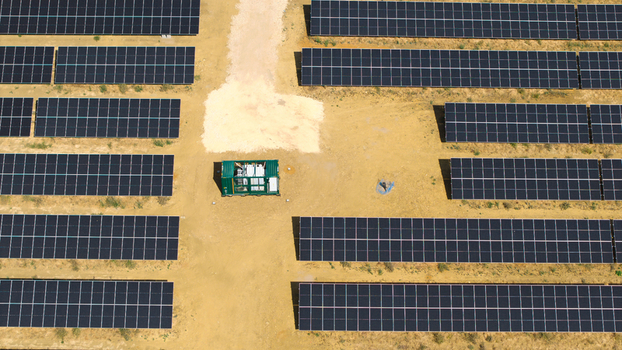 Aerial view of the Eaton Socon Substation featuring extensive rows of solar panels and battery energy storage systems on sandy ground in St. Neots England United Kingdom. Aerial view of the Eaton Socon Substation featuring extensive rows of solar panels and battery energy storage systems on sandy ground in St. Neots England United Kingdom.
