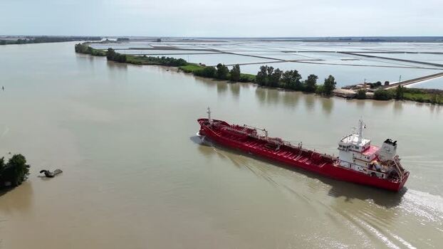 Aerial view of a red tanker ship on the Guadalquivir river Spain. Aerial view of a red tanker ship on the Guadalquivir river Spain.