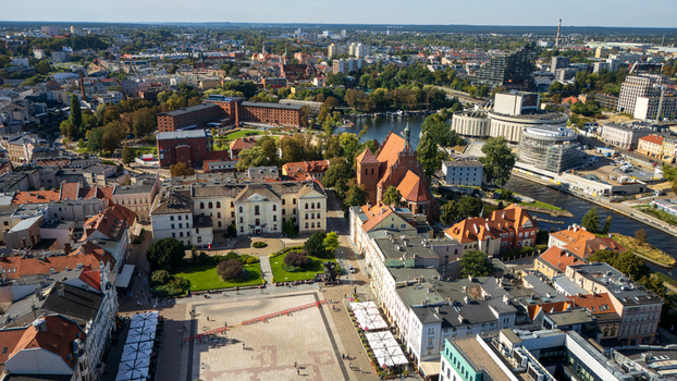 Aerial view of red roofed buildings contrasting with the green trees and winding river capturing the essence of the city s architectural charm Bydgoszcz Województwo kujawsko pomorskie Poland. Aerial view of red roofed buildings contrasting with the green trees and winding river capturing the essence of the city s architectural charm Bydgoszcz Województwo kujawsko pomorskie Poland.
