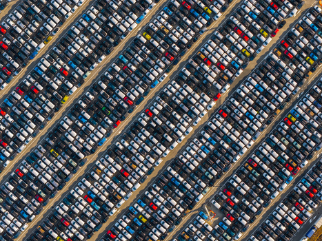 Aerial view of the automotive storage area at Civitavecchia Port with rows of new cars parked in organized diagonal lines under clear skies in Civitavecchia Lazio Italy. Aerial view of the automotive storage area at Civitavecchia Port with rows of new cars parked in organized diagonal lines under clear skies in Civitavecchia Lazio Italy.