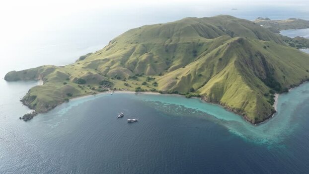 Aerial view of Komodo Island and boats in the bay Indonesia. Aerial view of Komodo Island and boats in the bay Indonesia.