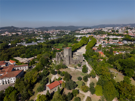 Aerial view of Guimaraes Castle surrounded by lush green parkland and historic buildings in Guimaraes Braga Portugal. Aerial view of Guimaraes Castle surrounded by lush green parkland and historic buildings in Guimaraes Braga Portugal.