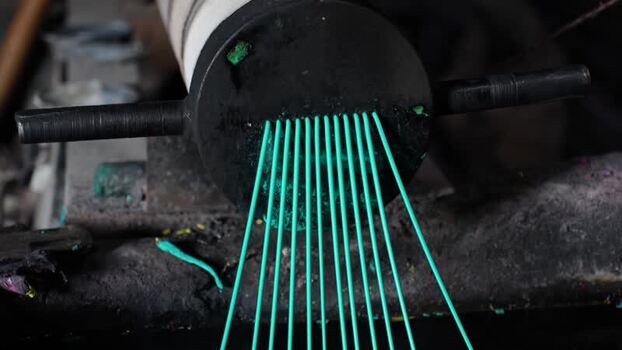 View of green plastic filaments being extruded Bangladesh. View of green plastic filaments being extruded Bangladesh.