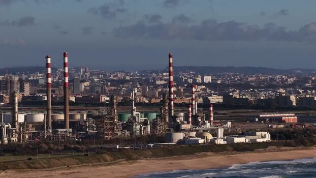 Aerial view of refinery with red and white chimneys Portugal.