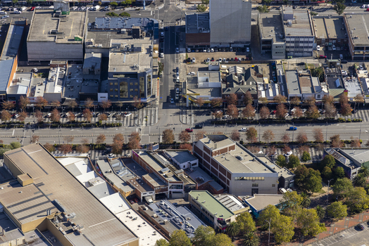 Aerial view of 272 Lonsdale St and surrounding urban buildings with streets and trees in Dandenong Victoria Australia.