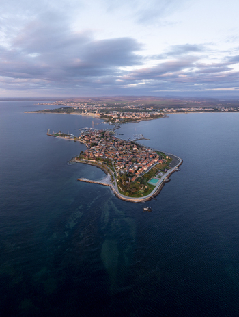 Aerial view of the historic peninsula of Nessebar with its ancient stone buildings terracotta rooftops and surrounding Black Sea waters in Nessebar Burgas Bulgaria. Aerial view of the historic peninsula of Nessebar with its ancient stone buildings terracotta rooftops and surrounding Black Sea waters in Nessebar Burgas Bulgaria.