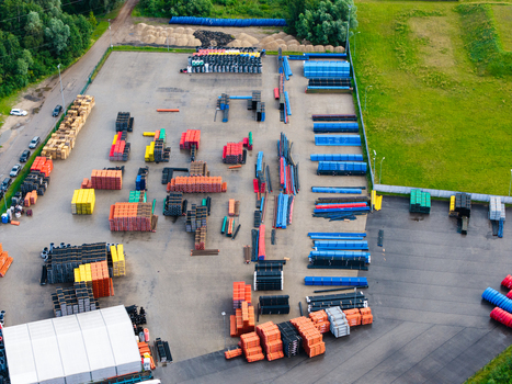 Aerial view of industrial storage yard with stacks of colorful polymer pipes and manufacturing components organized in an outdoor facility in Jelgava Latvia. Aerial view of industrial storage yard with stacks of colorful polymer pipes and manufacturing components organized in an outdoor facility in Jelgava Latvia.