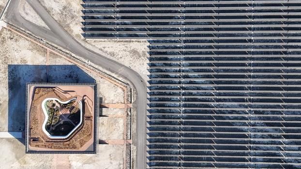 Aerial view of Karapinar Gunes Enerjisi Santrali a massive solar power plant with rows of photovoltaic panels and a modern central building Karapinar Konya Turkiye.