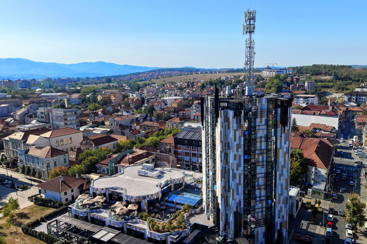 Aerial view of the modern tower and surrounding urban landscape with rooftops and streets in Krusevac Rasina District Serbia. Aerial view of the modern tower and surrounding urban landscape with rooftops and streets in Krusevac Rasina District Serbia.