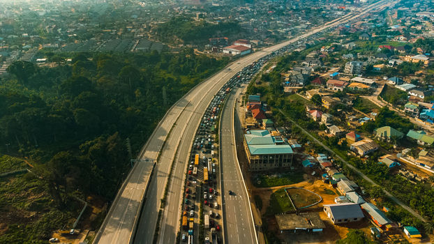 Aerial view of Pokuase interchange with heavy traffic on the multi level highway surrounded by urban residential areas and lush greenery in Ga North Municipal Greater Accra Region Ghana. Aerial view of Pokuase interchange with heavy traffic on the multi level highway surrounded by urban residential areas and lush greenery in Ga North Municipal Greater Accra Region Ghana.