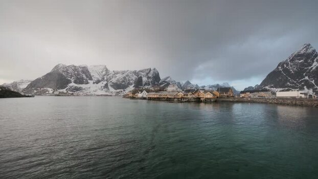 View of Hamn&oslash;y village with snow capped mountains Norway.