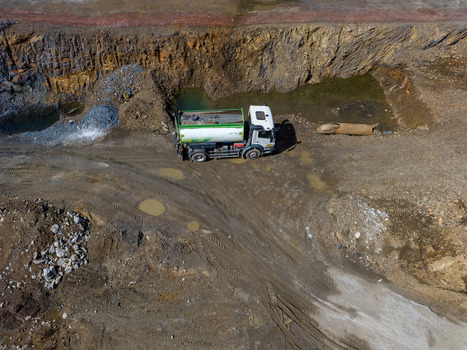 Aerial view of a tanker truck parked in a muddy quarry with rocky terrain and puddles in Istanbul Istanbul Turkiye. Aerial view of a tanker truck parked in a muddy quarry with rocky terrain and puddles in Istanbul Istanbul Turkiye.