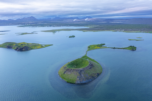 Aerial view of Lake Myvatn with its volcanic craters lush green islands and surrounding wetlands in Thingeyjarsveit Iceland.