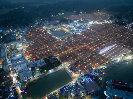 Aerial view of a bustling cityscape with bright lights illuminating the structures and waterways Charmonai Barisal Division Bangladesh. Aerial view of a bustling cityscape with bright lights illuminating the structures and waterways Charmonai Barisal Division Bangladesh.