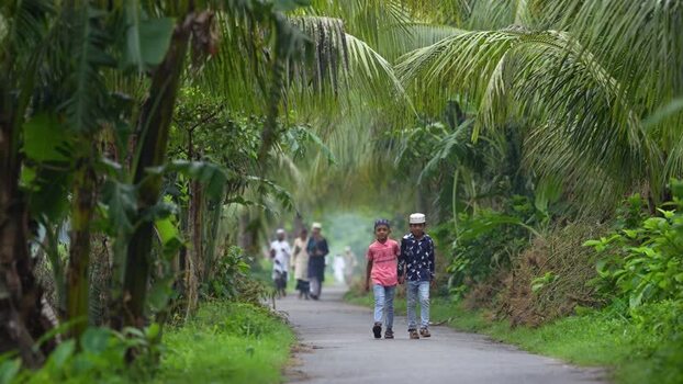 View of children walking on a rural road in Bogura Bangladesh. View of children walking on a rural road in Bogura Bangladesh.