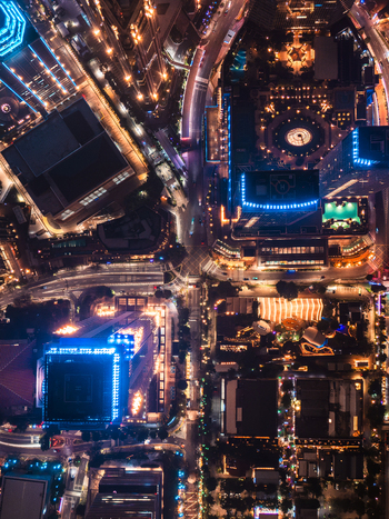 Aerial view of illuminated skyscrapers and city streets at night in Jakarta Indonesia.