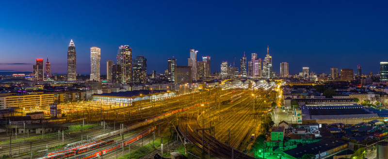 Aerial view of the Hauptbahnhof central station and the illuminated skyline with skyscrapers under a twilight sky Frankfurt am Main Hessen Germany.