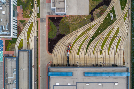 Aerial view of the Zajezdnia Annopol 01 tram depot featuring intricate track layouts a tram and surrounding green spaces Warsaw Masovian Voivodeship Poland. Aerial view of the Zajezdnia Annopol 01 tram depot featuring intricate track layouts a tram and surrounding green spaces Warsaw Masovian Voivodeship Poland.