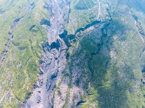 Aerial view of the volcanic landscape of Mount Semeru showing deep erosion channels and rocky terrain left by catastrophic eruptions near Pronojiwo East Java Indonesia.