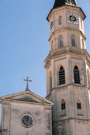 View of the historic octagonal tower and clock faces of St. Michael s Church against a clear blue sky in Vienna Vienna Austria. View of the historic octagonal tower and clock faces of St. Michael s Church against a clear blue sky in Vienna Vienna Austria.