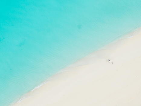 Aerial view of turquoise waters meeting the pristine white sands a tranquil paradise unfolds beneath the drone s gaze Vashafaru Island Maldives. Aerial view of turquoise waters meeting the pristine white sands a tranquil paradise unfolds beneath the drone s gaze Vashafaru Island Maldives.