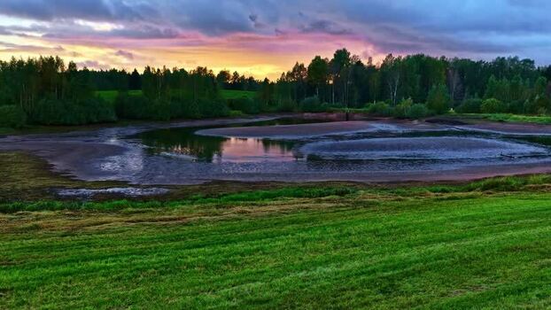 Aerial view of a serene pond at sunset Latvia. Aerial view of a serene pond at sunset Latvia.