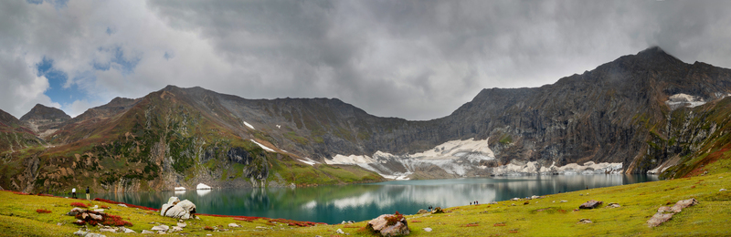 View of the stunning Ratti Gali Lake surrounded by majestic mountains glaciers and lush green meadows under a cloudy sky in Neelum Kashmir Pakistan. View of the stunning Ratti Gali Lake surrounded by majestic mountains glaciers and lush green meadows under a cloudy sky in Neelum Kashmir Pakistan.