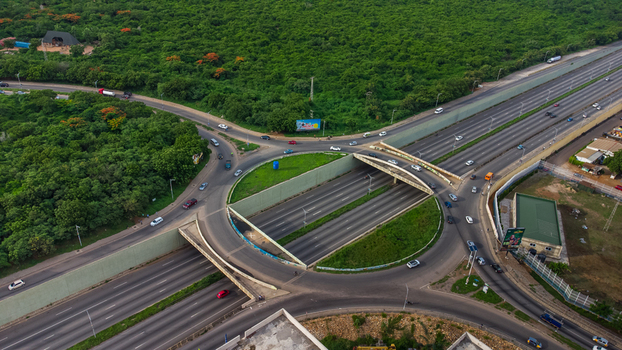 Accra Ghana 02 June 2023 Aerial view of the Forever roundabout featuring a multi level interchange with traffic flowing through the circular junction and surrounding lush green vegetation. Accra Ghana 02 June 2023 Aerial view of the Forever roundabout featuring a multi level interchange with traffic flowing through the circular junction and surrounding lush green vegetation.