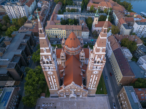 Aerial view of Szeged Cathedral with its prominent twin towers and central dome surrounded by the historic urban architecture and red tiled rooftops of Szeged Hungary. Aerial view of Szeged Cathedral with its prominent twin towers and central dome surrounded by the historic urban architecture and red tiled rooftops of Szeged Hungary.