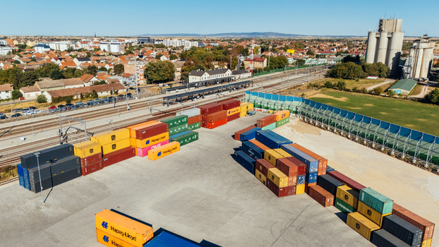 Indjija Serbia 24 August 2026 Aerial view of a container terminal with colorful shipping containers stacked in a yard next to a railway line and industrial buildings.