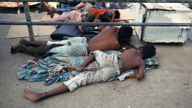 View of people sleeping on the ground at Sadarghat Bangladesh.