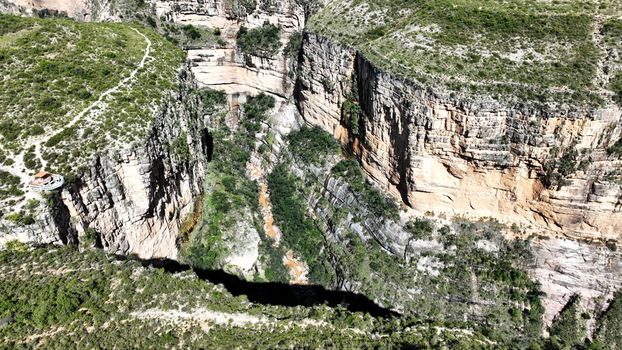Aerial view of the El Vergel canyon featuring steep rocky cliffs lush vegetation and a winding river in Torotoro Potosi Department Bolivia. Aerial view of the El Vergel canyon featuring steep rocky cliffs lush vegetation and a winding river in Torotoro Potosi Department Bolivia.